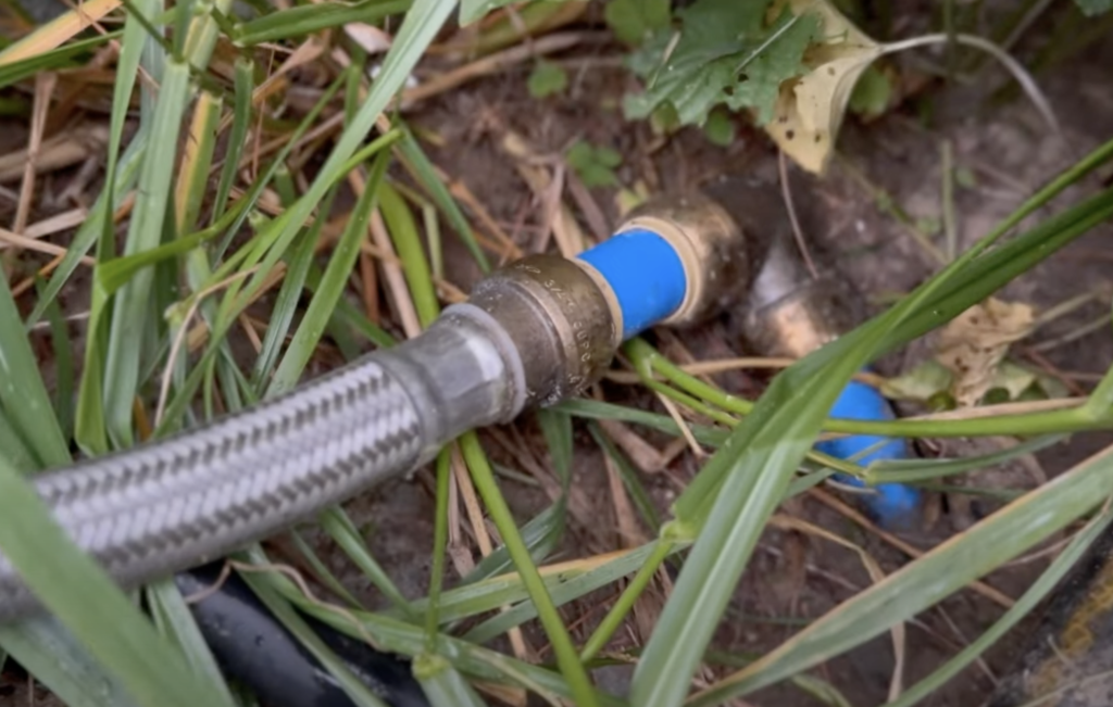 PEX tubing connected to a SharkBite elbow, leading to a braided line, and finally attaching to the existing house faucet.